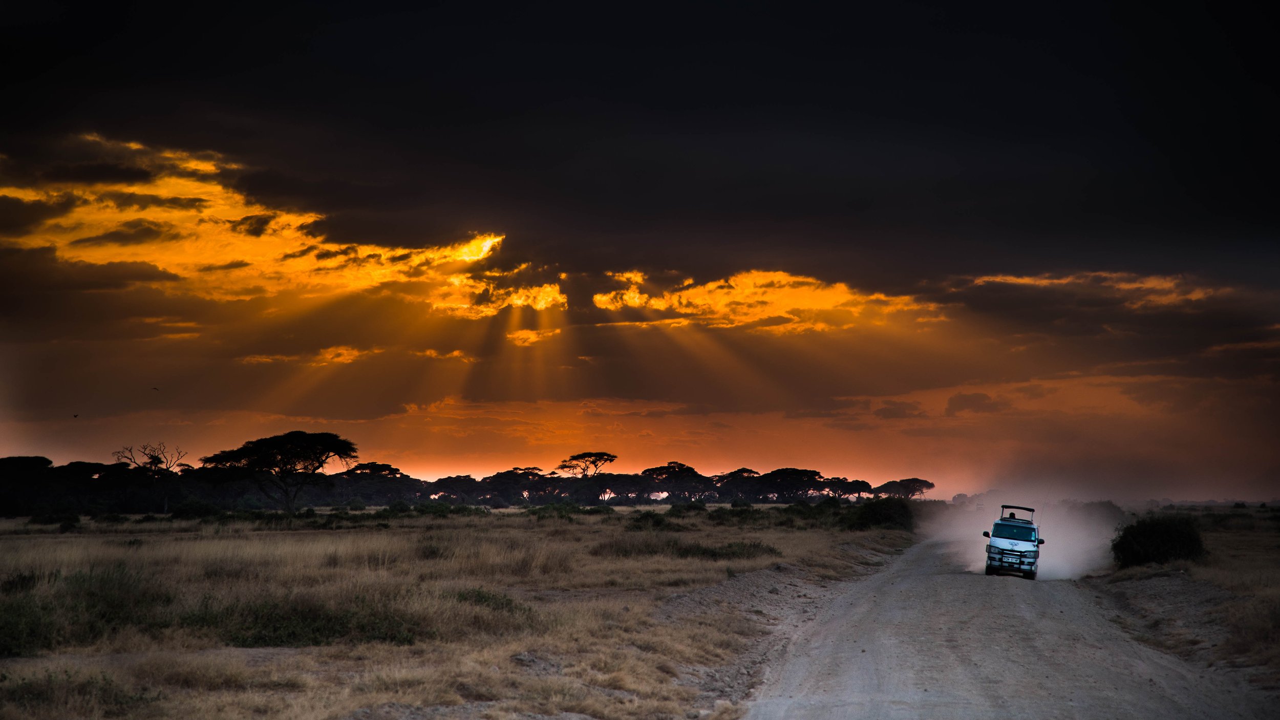 More than just a safari — safari jeep at dramatic sunset, Masai Mara